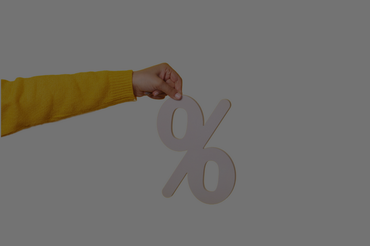 What percentage does a consignment shop take? Image of hand holding percentage sign.