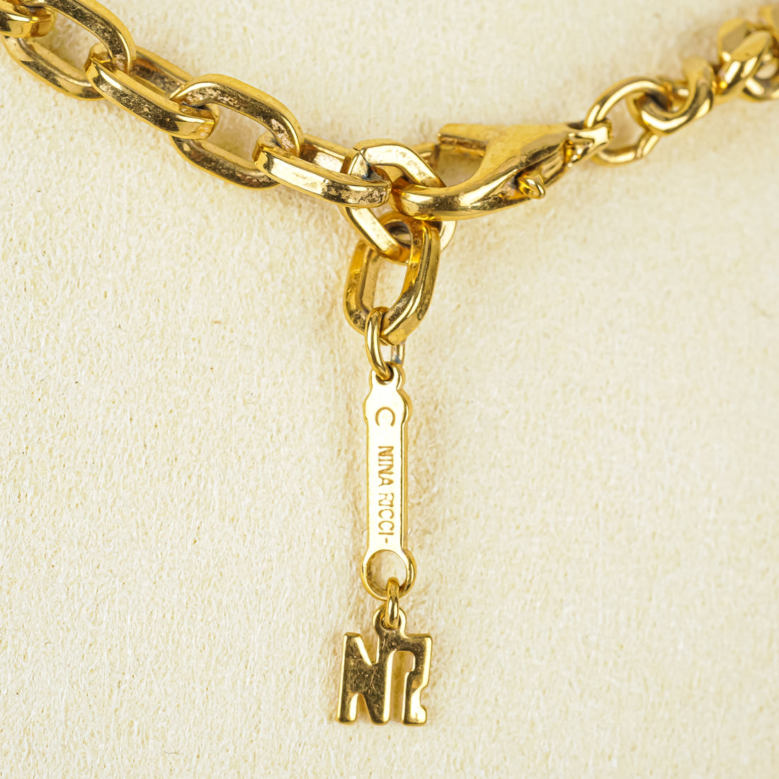 NINA RICCI Gold-Tone Cuban Chain Clear/Purple Cubic Zirconia