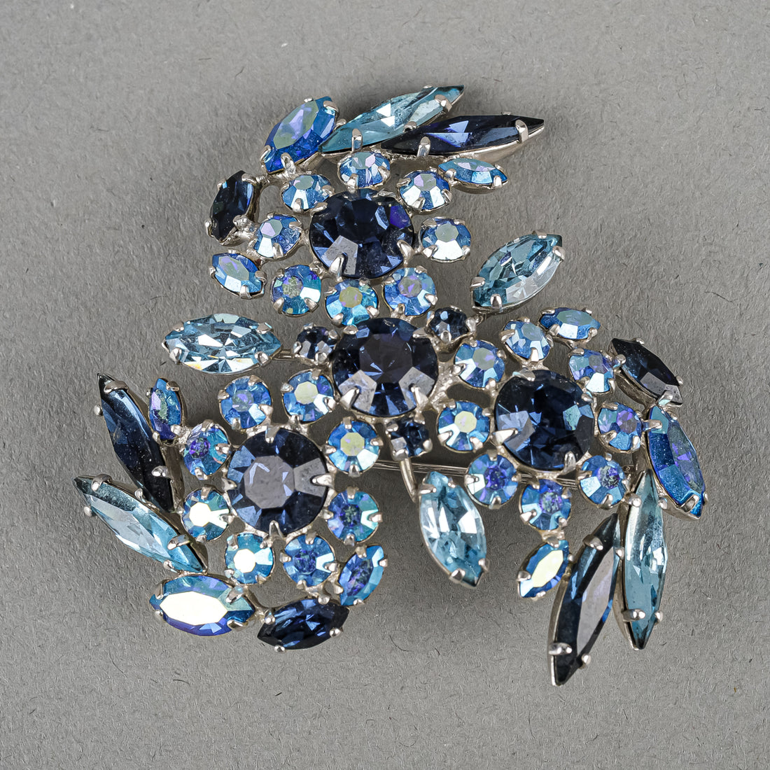 SHERMAN Silver Tone Blue Rhinestones Pinwheel Brooch